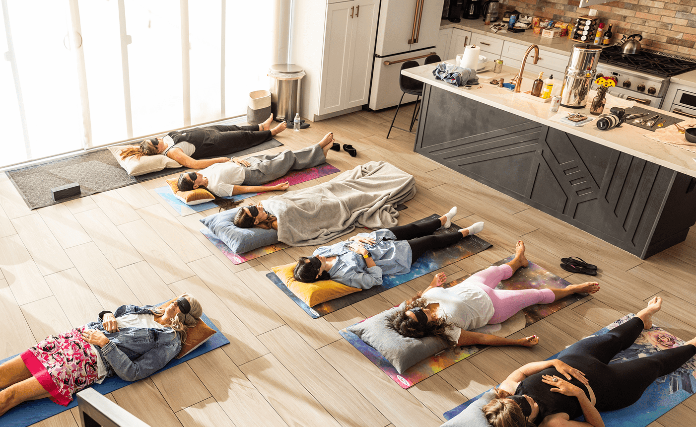 Participants resting on mats during a guided breathwork session